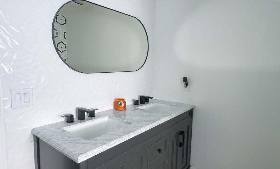 7410 Southwest 15th Street Plantation, FL 33317 - Photo 13 of 14 a bathroom with a granite countertop sink and a mirror