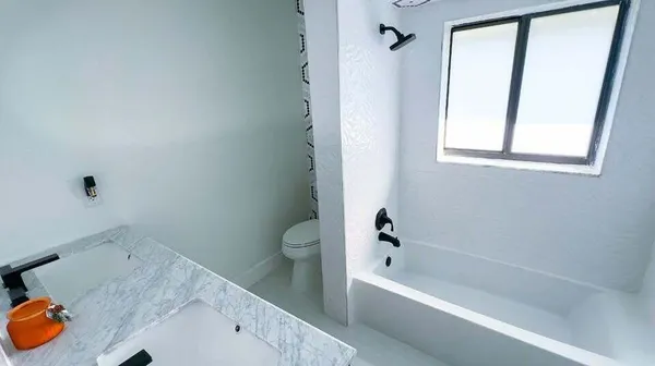 a bath room with a bath tub and a shower