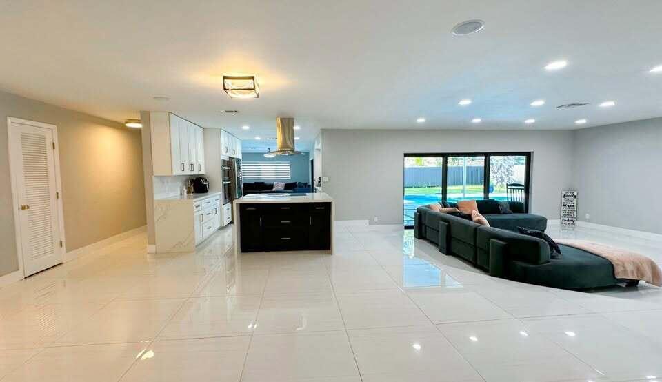 7410 Southwest 15th Street Plantation, FL 33317 - Photo 7 of 14 a large white kitchen with a large counter top a sink a stove and a refrigerator
