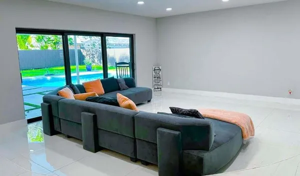 a bedroom with furniture and a large window