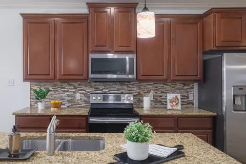 a kitchen with a stove microwave and cabinets