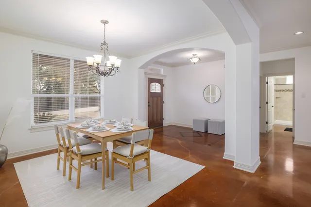 a view of a dining room with furniture and window