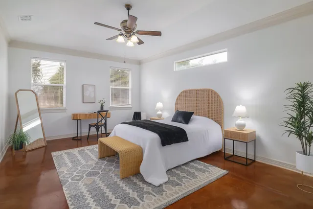 a bedroom with furniture and a chair