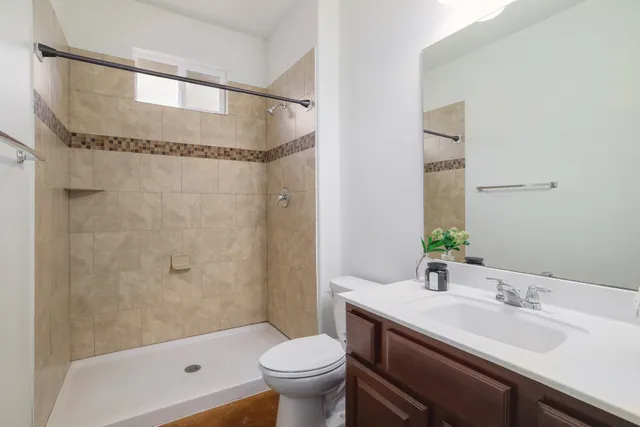 a bathroom with a sink toilet and shower