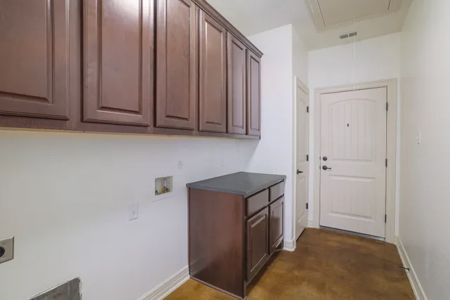 a view of a storage and utility room with washer and dryer