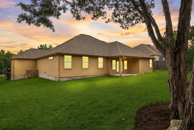a front view of a house with a garden