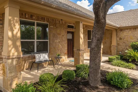 a front view of a house with garden