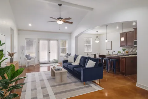 a living room with furniture or kitchen view and a chandelier