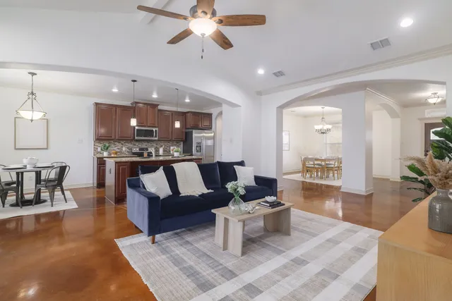 a living room with furniture and kitchen view