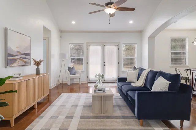 a living room with furniture and large windows