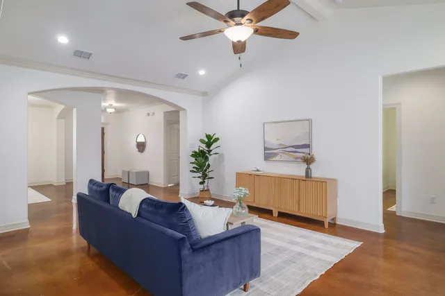 a living room with furniture and a wooden floor