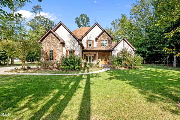 a front view of house with yard and green space