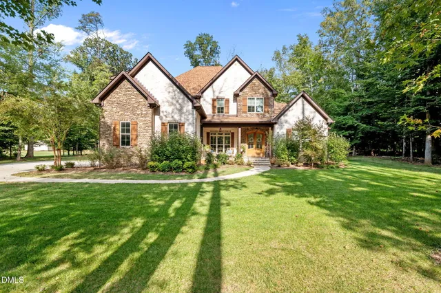 a front view of house with yard and green space