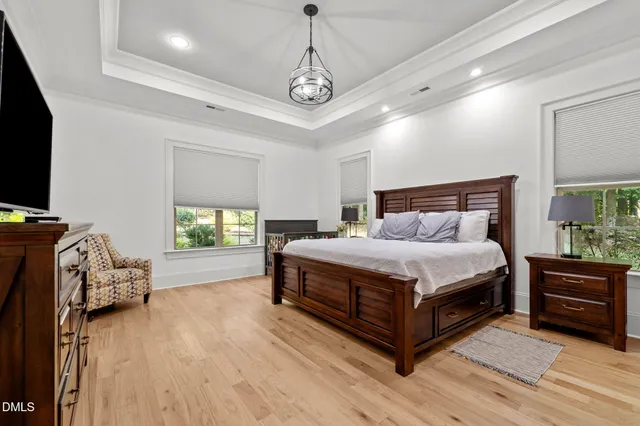 a bedroom with a bed and a tv on table