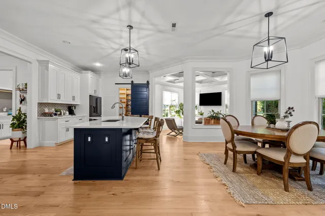 a view of kitchen with sink dining table and chairs
