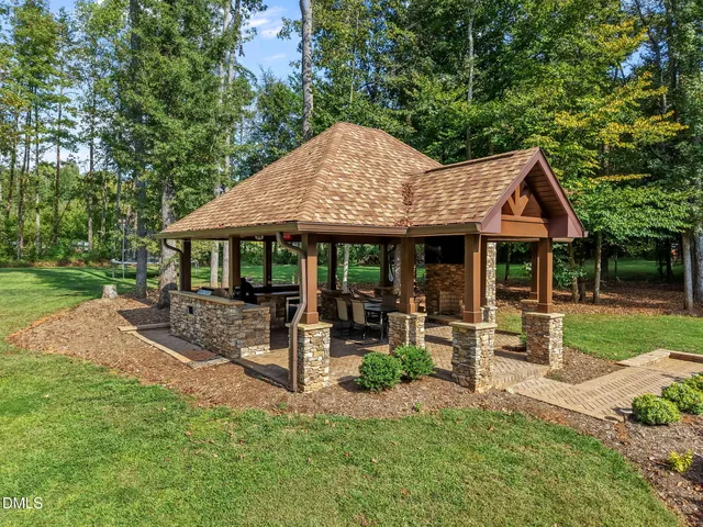 a living room with patio furniture and a floor to ceiling window