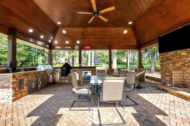 a view of a house with roof yard and sitting area