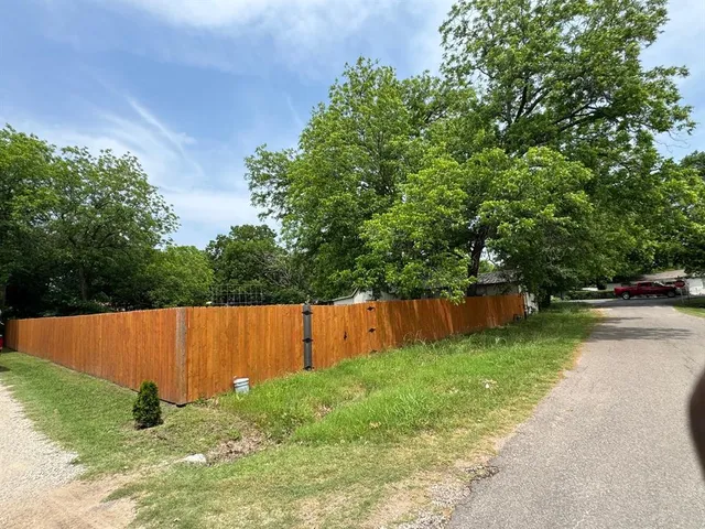 a view of backyard with swimming pool and outdoor seating