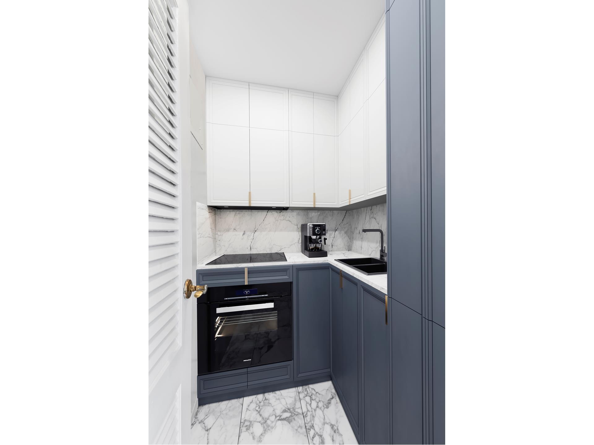 150 East 37th Street, Unit 12C Manhattan, NY 10016 - Photo 3 of 6 a kitchen with a sink and cabinets