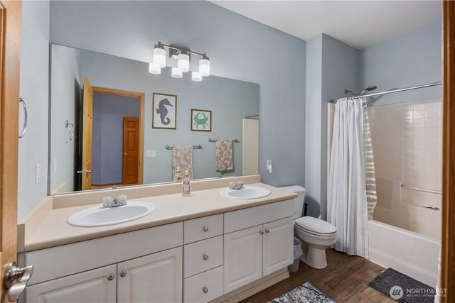 a bathroom with a toilet sink and mirror
