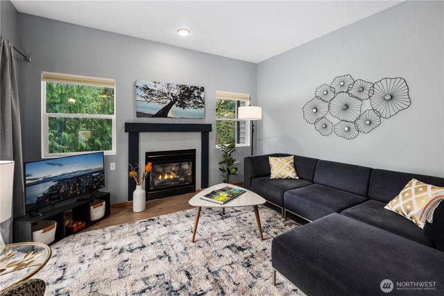 a living room with furniture a window and a fireplace