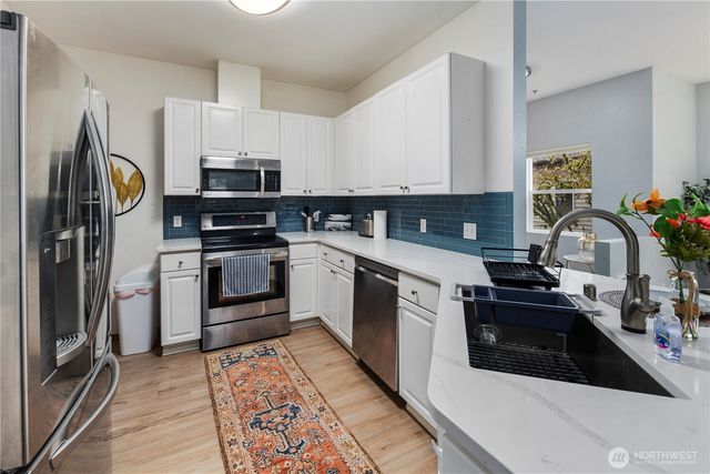 a kitchen with a stove a sink and a refrigerator