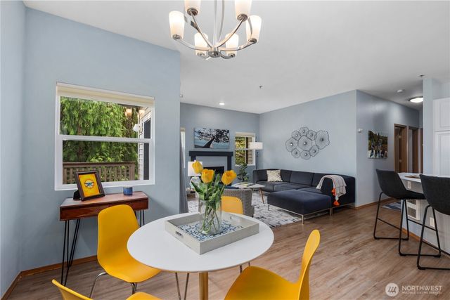 a living room with furniture a chandelier and a window