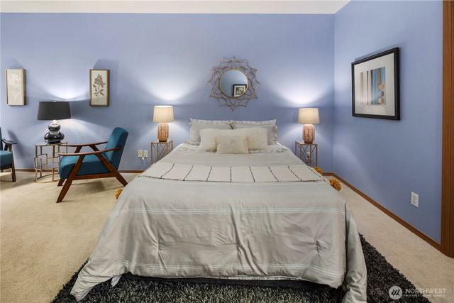 a bedroom with a bed and a lamp on table