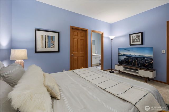 a bedroom with a bed and a fireplace