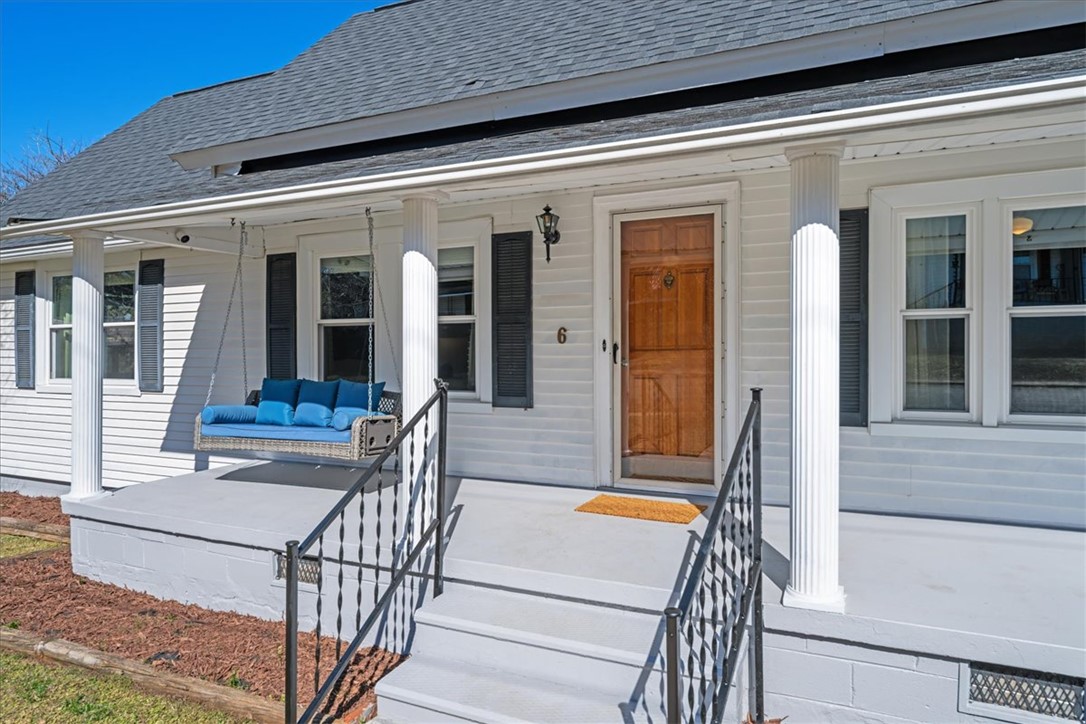 This charming residence features a welcoming front porch, perfect for enjoying peaceful moments outdoors.