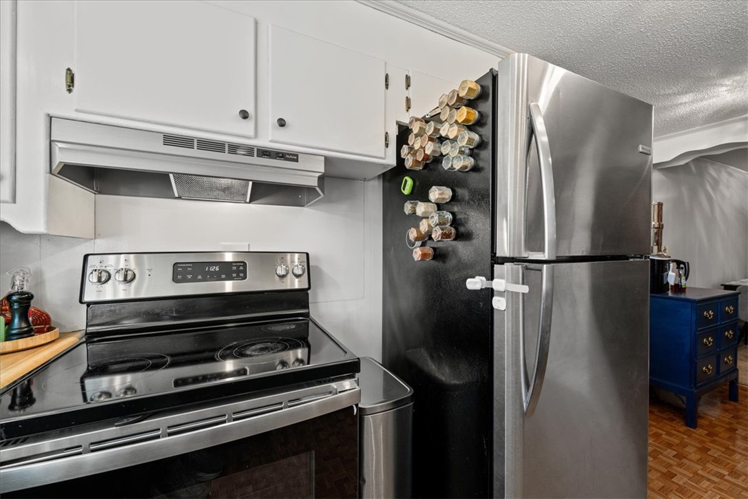 6 Fuller Street Pelzer, SC 29669 - Photo 12 of 36 This modern kitchen features essential appliances, offering practical design and functionality.