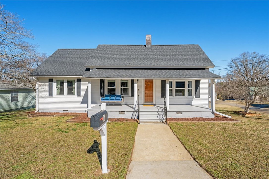 6 Fuller Street Pelzer, SC 29669 - Photo 2 of 36 This charming home offers a welcoming facade with a classic porch and inviting curb appeal.