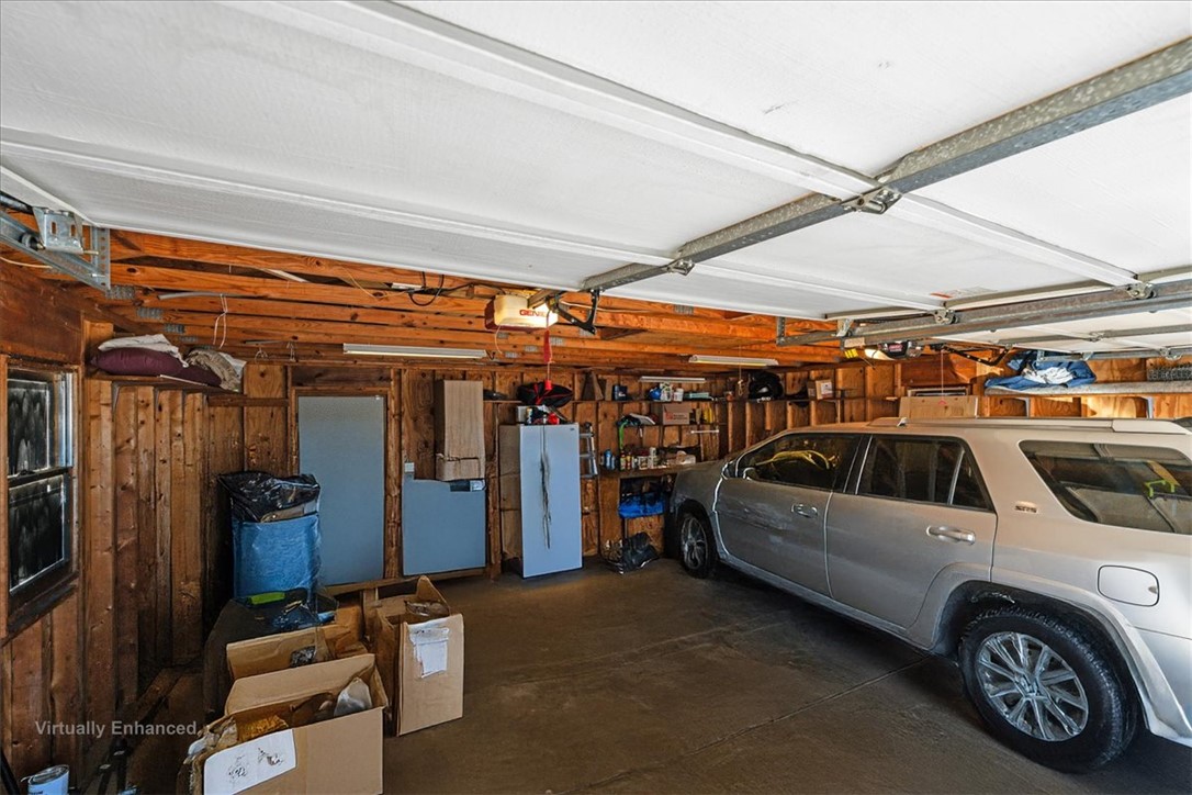 6 Fuller Street Pelzer, SC 29669 - Photo 33 of 36 This spacious garage offers ample room for vehicles and storage, blending functionality with rustic charm.