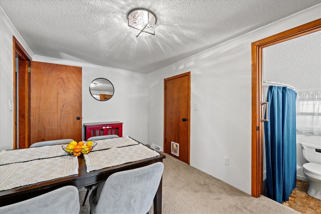 6 Fuller Street Pelzer, SC 29669 - Photo 8 of 36 This bright and functional dining area transitions seamlessly into a well-appointed bathroom.