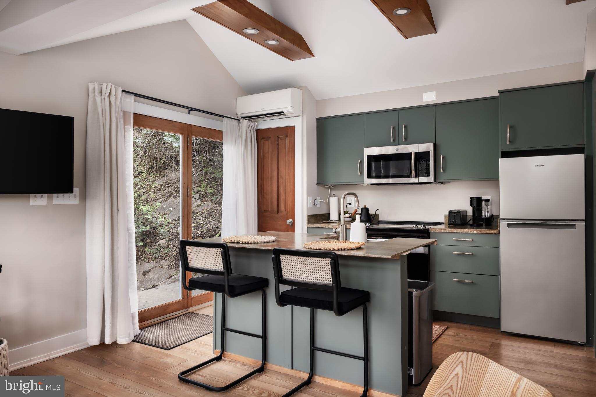 730 Bennys Beach Road Front Royal, VA 22630 - Photo 14 of 44 a kitchen with a table chairs refrigerator and microwave