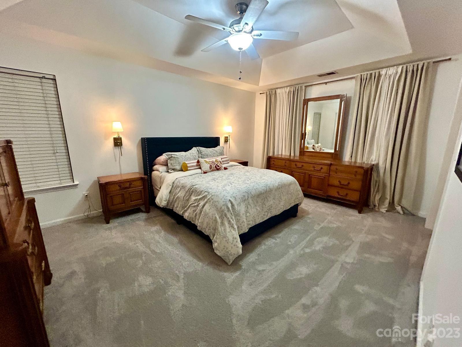 9724 Steele Meadow Road Charlotte, NC 28273 - Photo 11 of 21 a bedroom with a bed and a chandelier