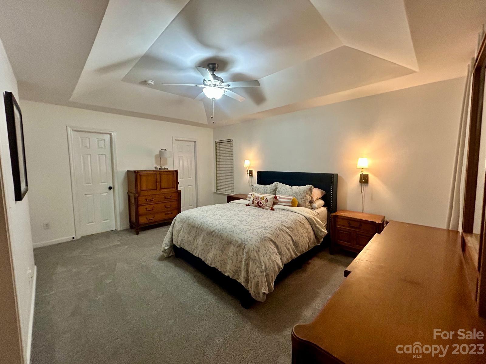 9724 Steele Meadow Road Charlotte, NC 28273 - Photo 13 of 21 a spacious bedroom with a bed and a chandelier