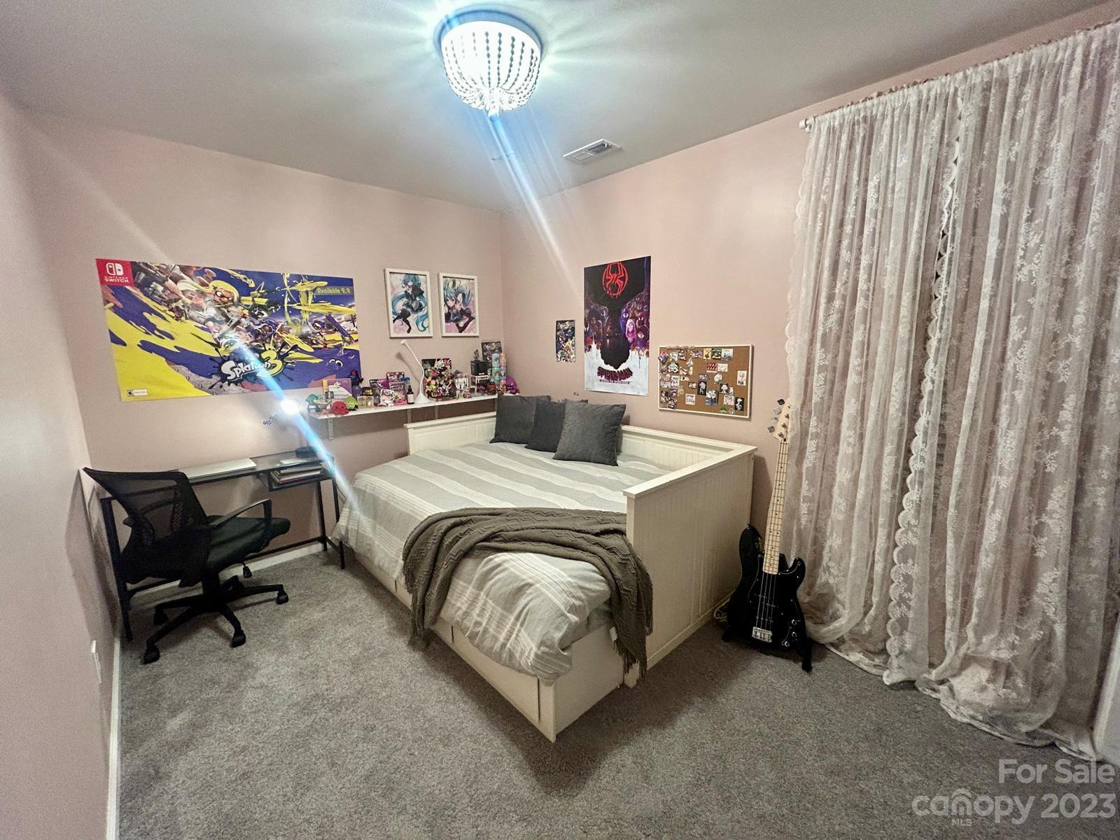 9724 Steele Meadow Road Charlotte, NC 28273 - Photo 19 of 21 a bedroom with a bed and a chandelier