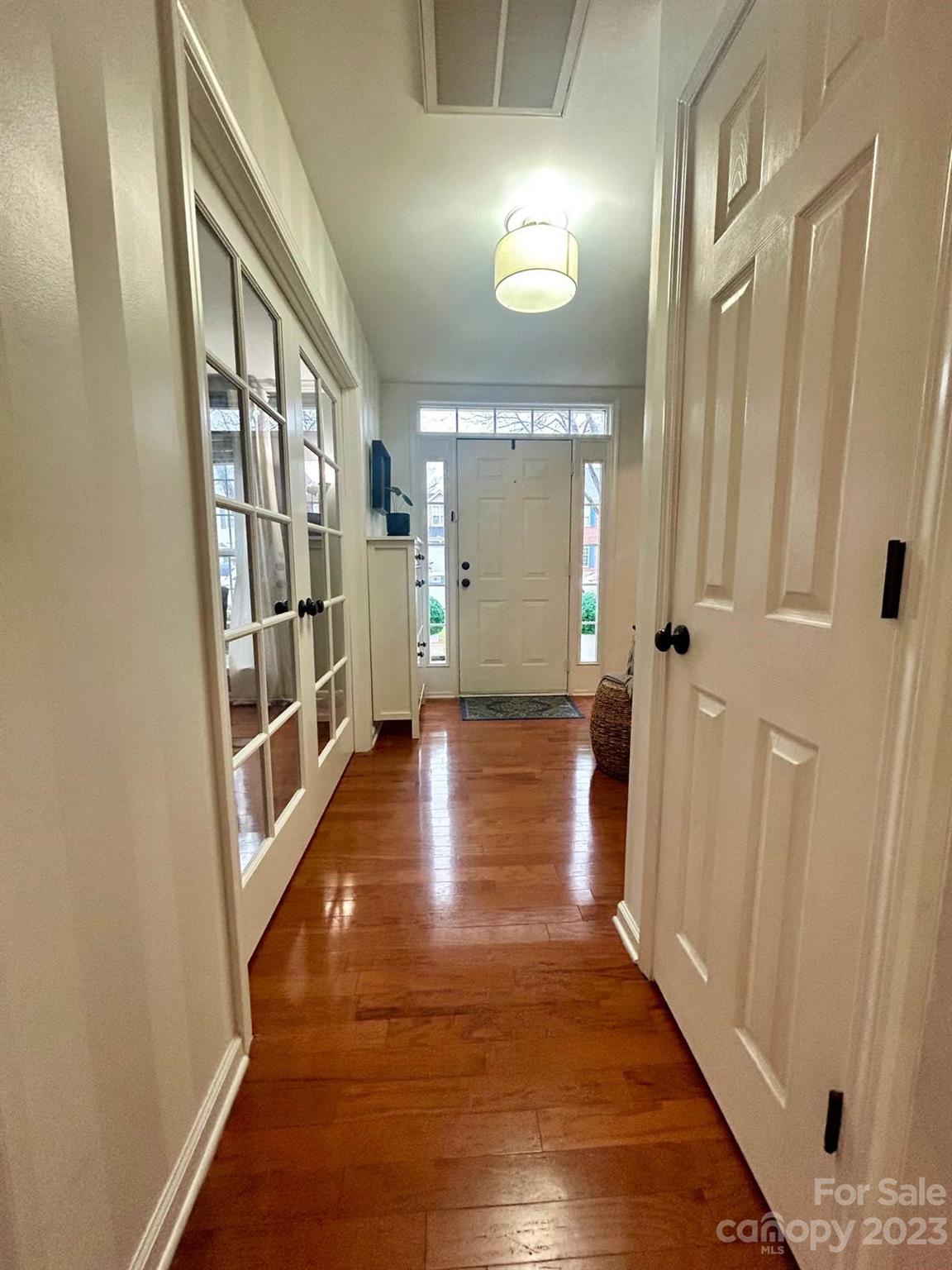 9724 Steele Meadow Road Charlotte, NC 28273 - Photo 7 of 21 a view of a hallway with wooden floor and staircase