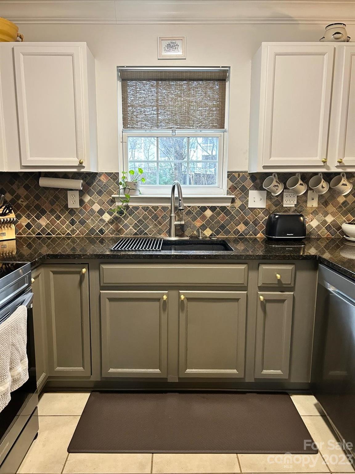 9724 Steele Meadow Road Charlotte, NC 28273 - Photo 9 of 21 a kitchen with stainless steel appliances granite countertop a sink cabinets and a granite counter top