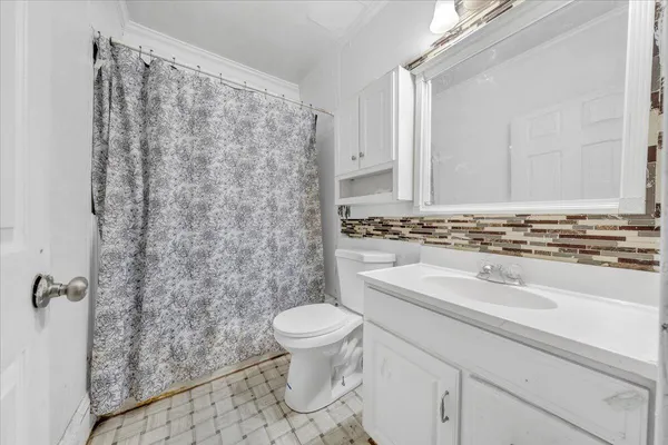 a bathroom with a sink a toilet and a shower