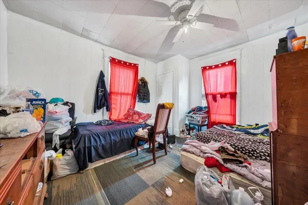 a bedroom with furniture and wooden floor