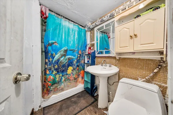 a bathroom with a sink toilet and shower