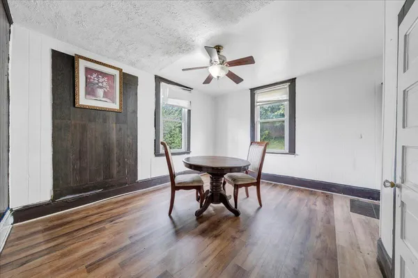a view of a dining room with furniture window and wooden floor