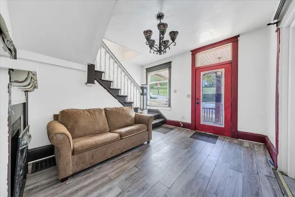 a living room with furniture and wooden floor