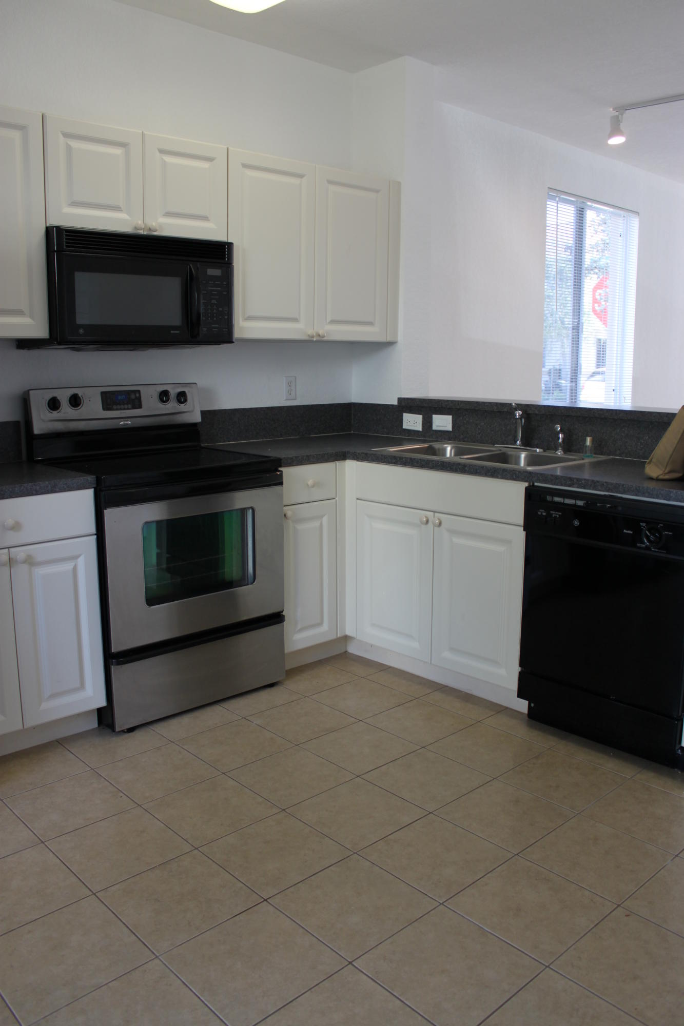1910 Hibiscus Lane Riviera Beach, FL 33404 - Photo 8 of 9 KITCHEN FROM PATIO