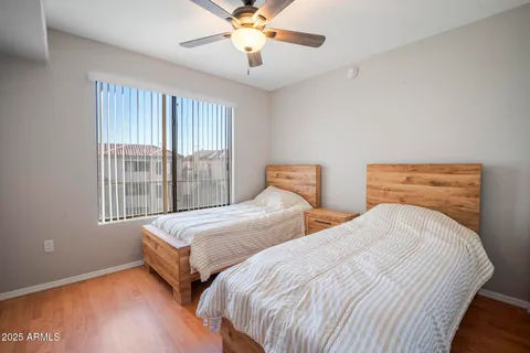 a bedroom with two beds and a chandelier