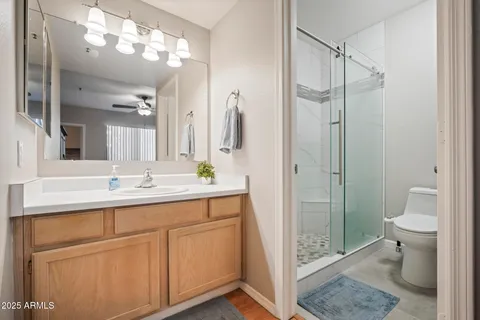 a bathroom with a sink a toilet and shower