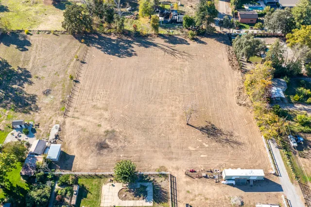 an aerial view of a houses with yard