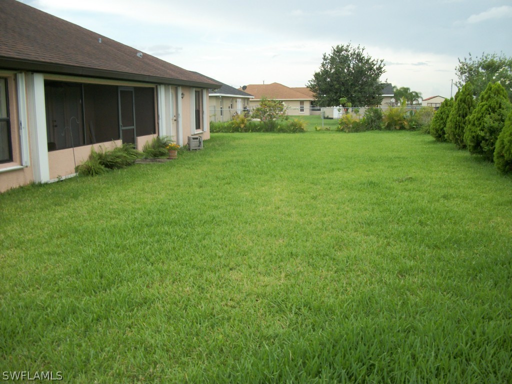 1019 Caribbean Avenue Clewiston, FL 33440 - Photo 15 of 16 a view of backyard of house with green space